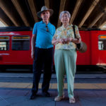 elderly couple on train platform