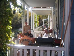 a community relaxing on a large porch