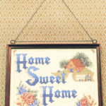 home sweet home needlepoint hanging on wall