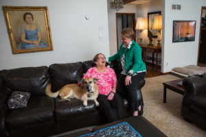 senior mother & daughter with a dog on a couch