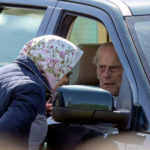 From his car window, Prince Philip talking with Queen Elizabeth II