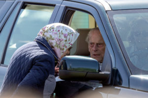 From his car window, Prince Philip talking with Queen Elizabeth II