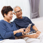 Senior Couple using smartphone together