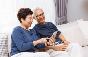Senior Couple using smartphone together