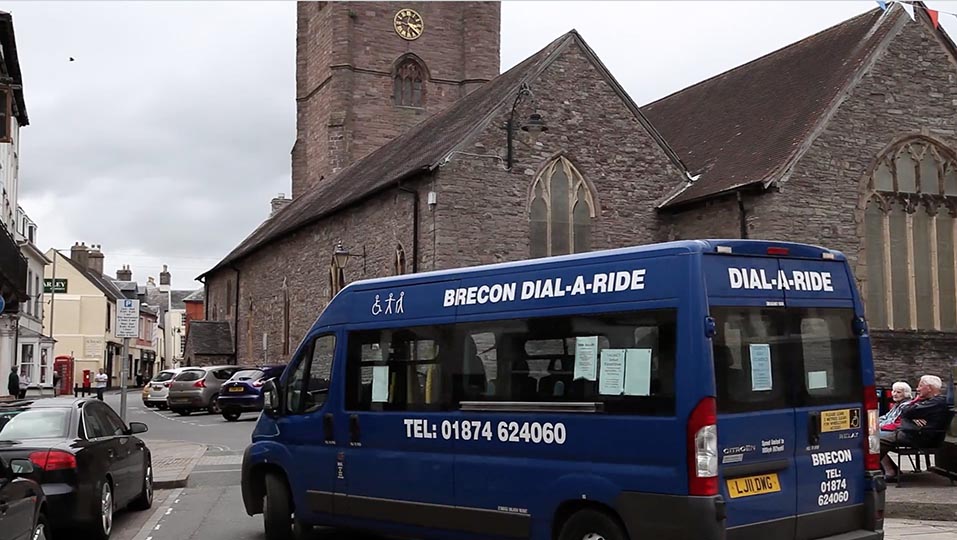 Dial-a-ride van turning a corner in the UK.